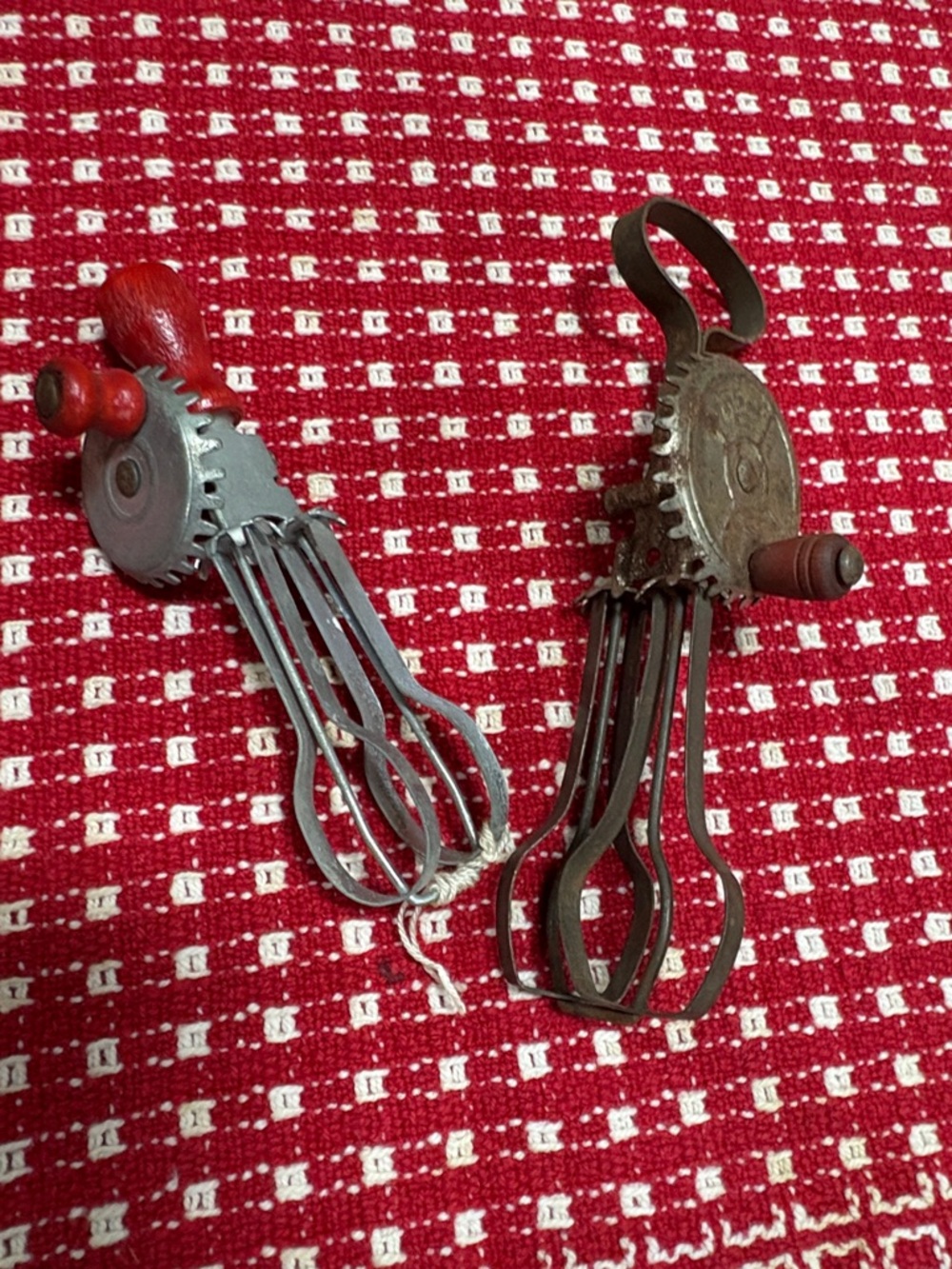 vintage Betty Taplin child's toy hand mixer, made of metal and red handled mixer